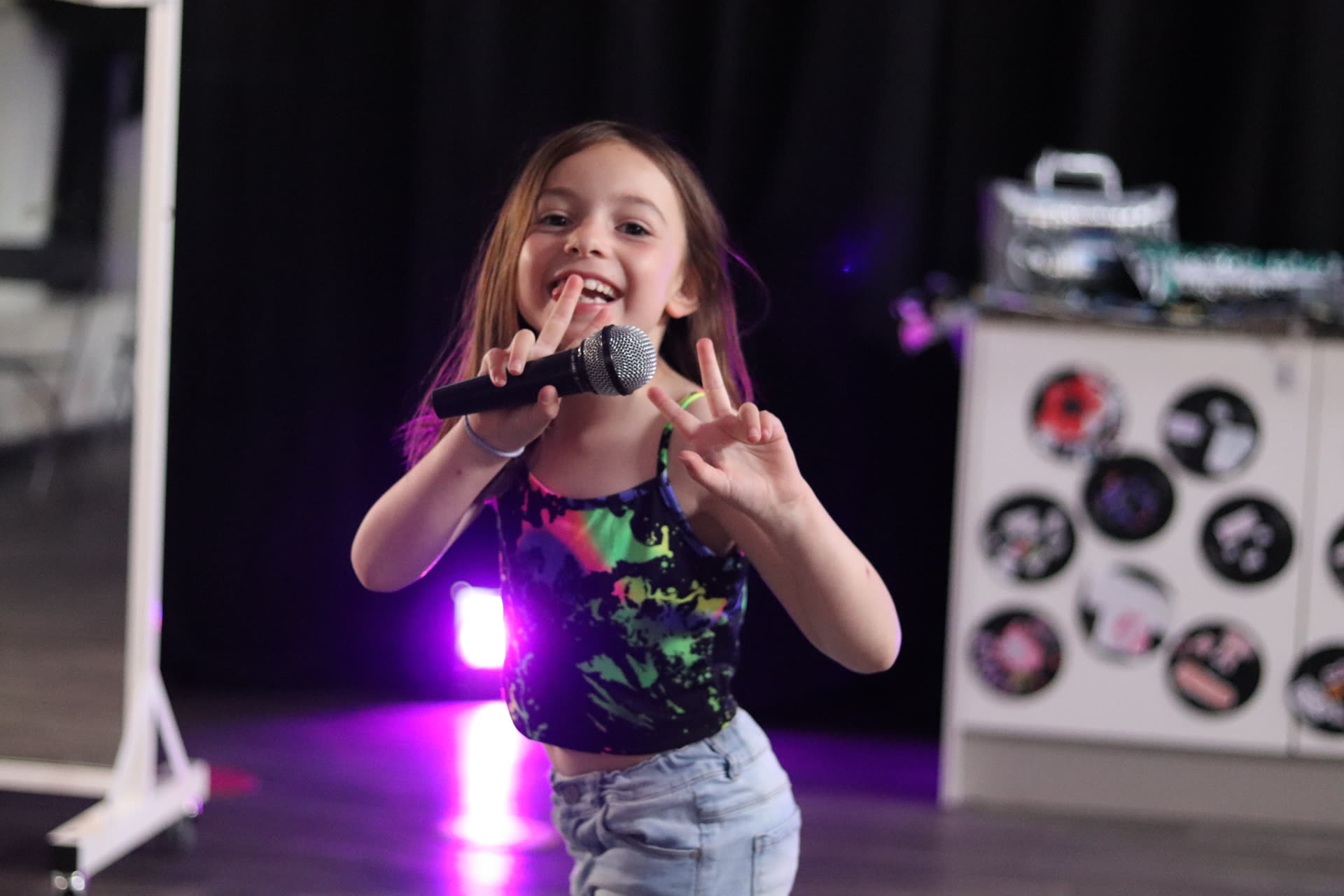 Young performer singing into a microphone